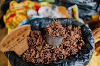 Star anise displayed in a can on a market stall, showcasing its rich, aromatic spice used in cooking.